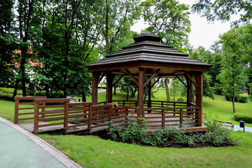 WIELICZKA, POLAND - 12 JULY 2022: Wooden gazebo in beautiful city park by the Salt Mine, Wieliczka, Poland.