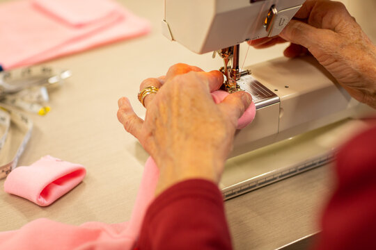 elderly hands operating sewing machine