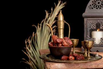 Tea and dried dates on a old wooden table.