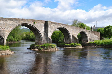 View of Ancient Stone Bridge and River on Sunny Day