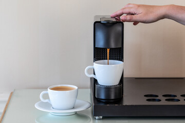 Capsule coffee machine. Making morning coffee