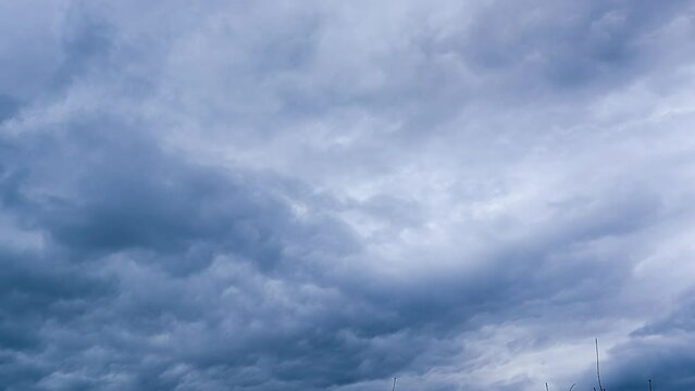Gloomy clouds covered the sky before the rain. Dark clouds move quickly across the sky. Timelapse