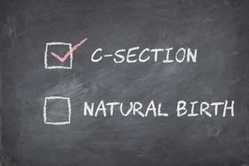The text C-section (cesarean birth) preference over natural birth on blackboard background. Person's choice for the mode of child birth concept.