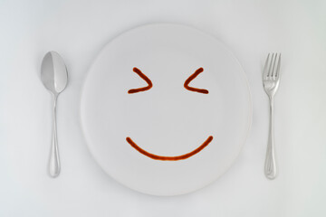 Smiling faces sauce on a white plate.Smiling symbol. Enjoy eating concept.