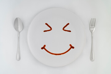 Smiling faces sauce on a white plate.Smiling symbol. Enjoy eating concept.