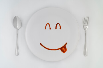 Smiling faces sauce on a white plate.Smiling symbol. Enjoy eating concept.