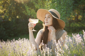 Young woman drink  wine in the sunset lavender field