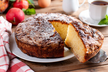 Sponge cake with apples on a table, selective focus. Homemade cake
