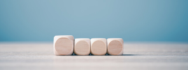 Square wooden blocks lined up on a wooden workbench