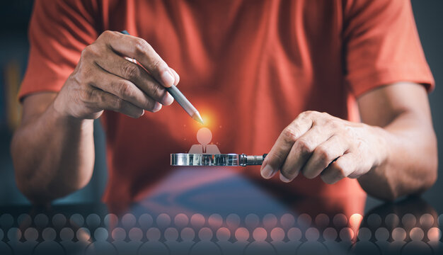 young man using a magnifying glass Choose a leader or employees and personnel who are leadership and professional for his business, Hiring or recruiting employees, including executives