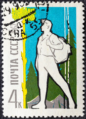 Soviet Union - circa 1962 : Cancelled postage stamp printed by Soviet Union, that shows Hiker at Camp, circa 1962.