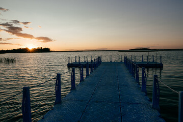 Fototapeta na wymiar Peaceful sunset with dramatic sky and bridge