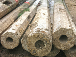 old concrete poles from the power line lie in a heap