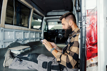 Naklejka premium An industry worker checking on bus construction in vehicle production factory.