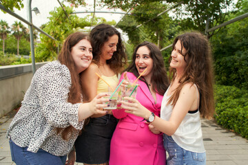Group of smiling girls toasting their friendship - Concept of happy lifestyle and friendship