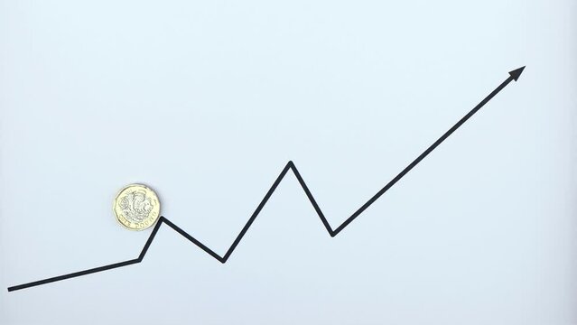 1 GB pound sterling coin moving up the rising line graph, reverse side up, currency value increase or appreciation concept.