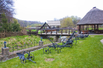 Agricultural old plow in front of green grass