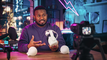 Stylish African American Man Recording a How To Video Review About Modern Virtual Reality Headset. Young Black Man Explaining New Features on Live Podcast on Social Media.