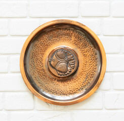 Mid-century modern bronze wall plate with a fish