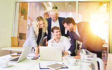 Group of business people at the computer as a team in meeting