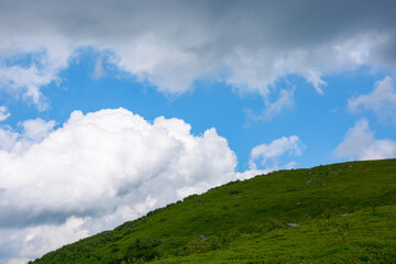 cumulus clouds above the hill. weather forecast in mountains. summer nature scenery