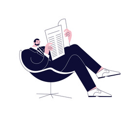 Young man sitting comfortably in a chair and reading