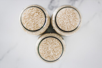 Fototapeta na wymiar glass jar with white rice of including jasmine basmati and sushi rice, healthy pantry ingredients