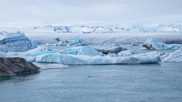 Beautiful view of icebergs floating in glacier lagoon. Scenic view of glacier ice formations. Idyllic scenery of Jokulsarlon glacier lagoon in Iceland. Beautiful Icelandic nature.