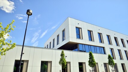 Office building with white aluminum composite panels. Facade wall made of glass and metal. Abstract modern business architecture.