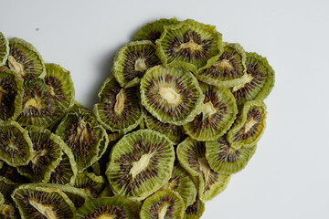 Close up of Natural Dried Kiwi Slices Snack in heart shape. Dried Kiwi for baking.  Isolated white background. Love concept, valentines concept.