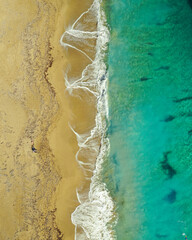 Aerial view of huge beach with waves crashing on the sand