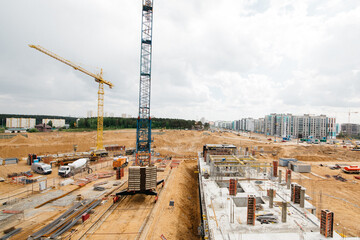 Construction site with high cranes. Construction of modern apartment buildings 