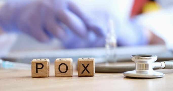 On the table are wooden cubes with the inscription pox