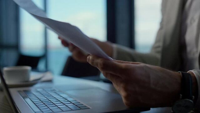Businessman hands holding papers in marine view office. Director with reports
