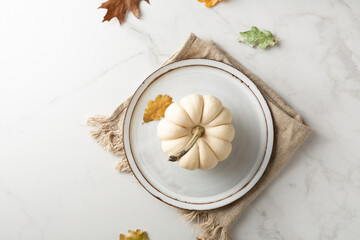 Overhead view of table setting with white pumpkin autumn concept