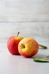 Two fresh organic apples on light surface harvest concept food copy space