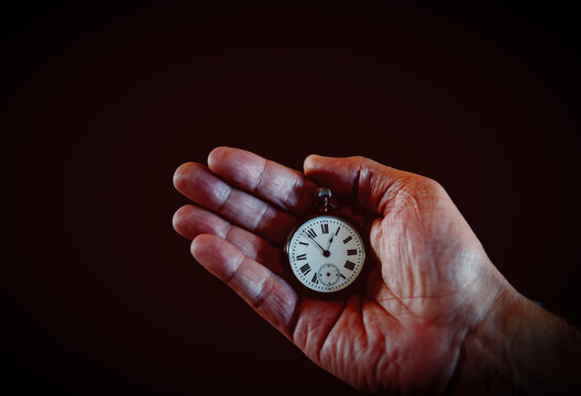 Abstract image Hands of elderly holding pocket watch in retro vintage style back and white color .Concept of man with theirs own time.