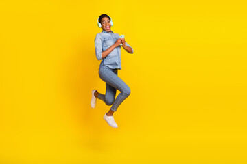 Fototapeta na wymiar Portrait of excited energetic person hold telephone enjoy free time summer isolated on yellow color background