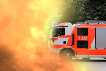 red fire truck in the courtyard of a multi-storey building arrives on call, emergency 112 concept for a fire in Germany, flashing lights