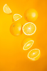 Orange fruits in flight.  Creative levitation food on orange background. 7 fruits