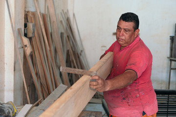 Mature carpentry shop owner working with wood