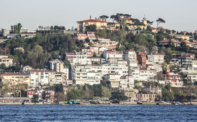 View over the houses and villas on the coastline of Bosphorus strait. View from the touristic boat during the cruise on Bosporus