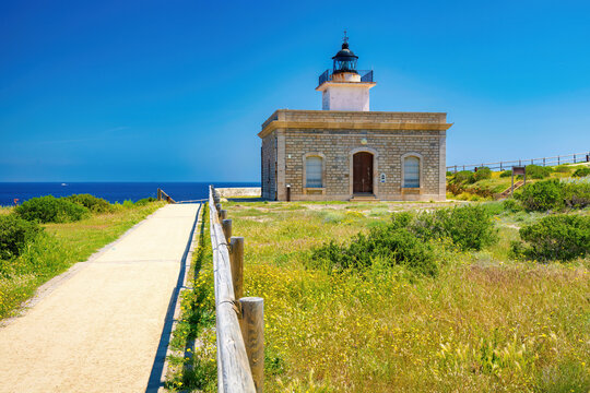 View of the main fa&ccedil;ade of the Punta de s'Aranella lighthouse on the coastal path from Port of Selva to Llan&ccedil;a. Costa Brava, Catalonia, Spain