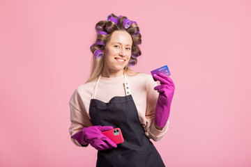 Bank card payment online using app on your phone. Smiling woman while clean dressed in apron and...