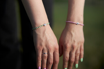 Modern beaded jewelry on the girl's hand. Rings and bracelets on the girl's hand. multi-colored jewelry made of beads and beads 