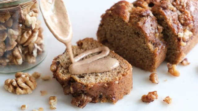 Vegan banana bread with almond butter and walnuts, closeup view. Sweet gluten free homemade quick bread