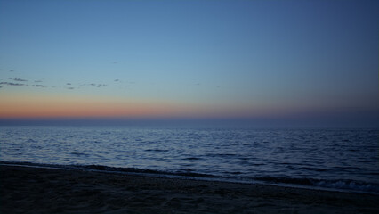 Beautiful view beach washed sea waves at evening. Amazing nature background.