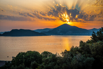 Vacation theme. Beautiful sunset, sea and mountains