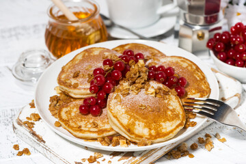 delicious pancakes with berries and honey for breakfast, closeup