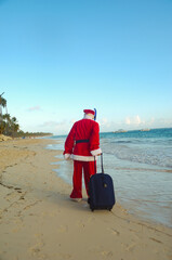 Santa Claus is on vacation on a tropical beach. - 517898967